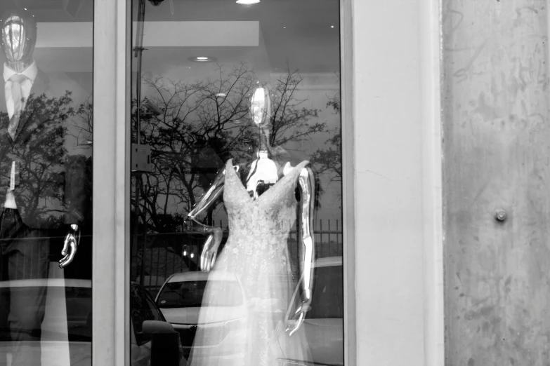 the wedding dress is on display in the window