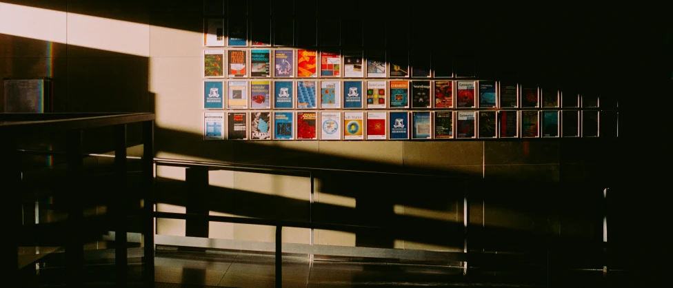 a stairway with posters hanging up on the side