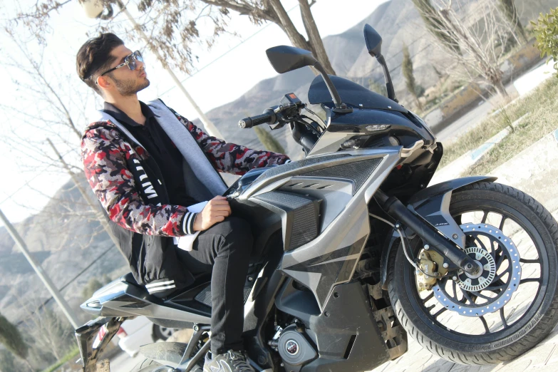 a man sitting on the seat of a motorcycle