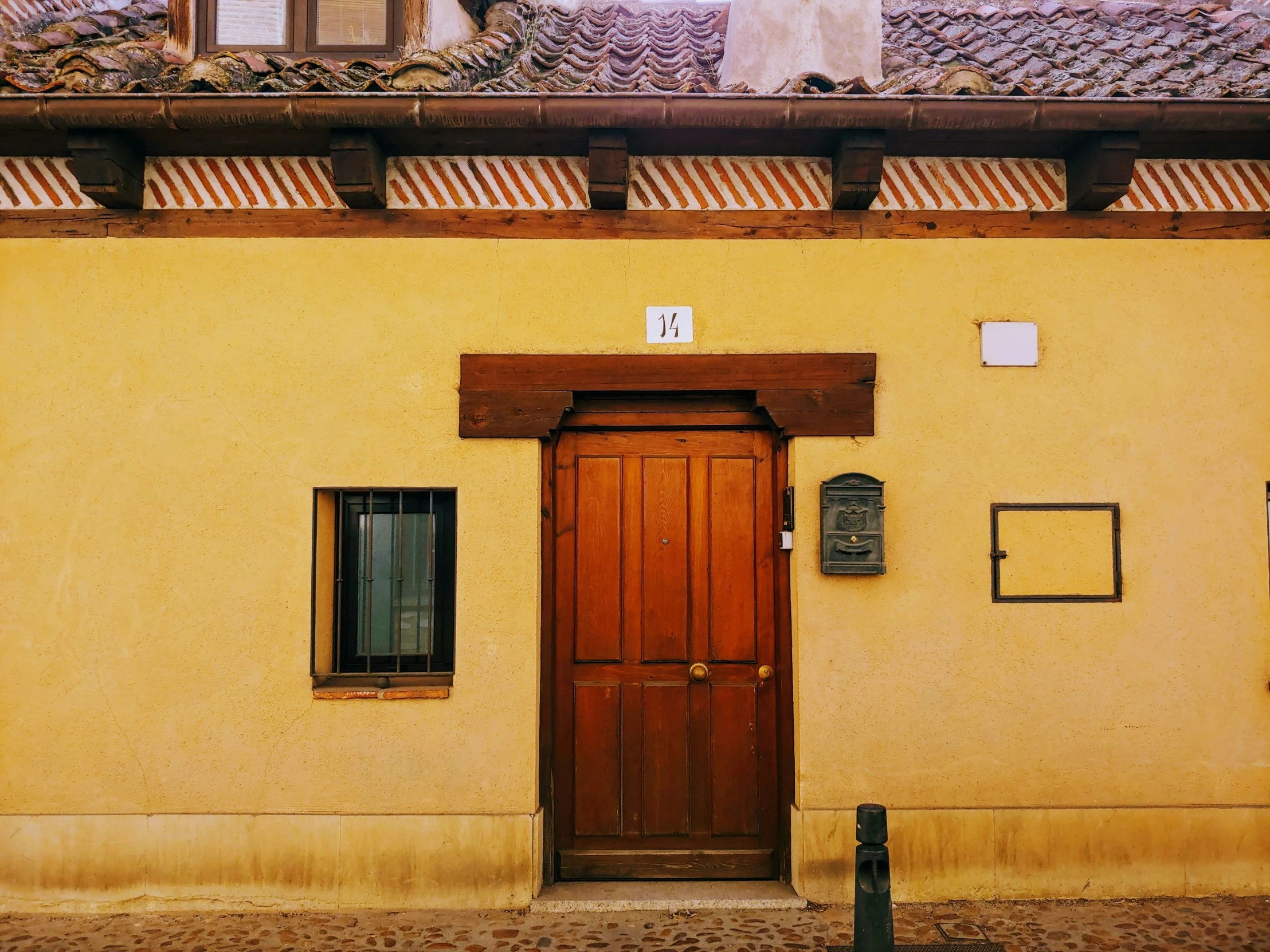 an old spanish styled house has a door and window