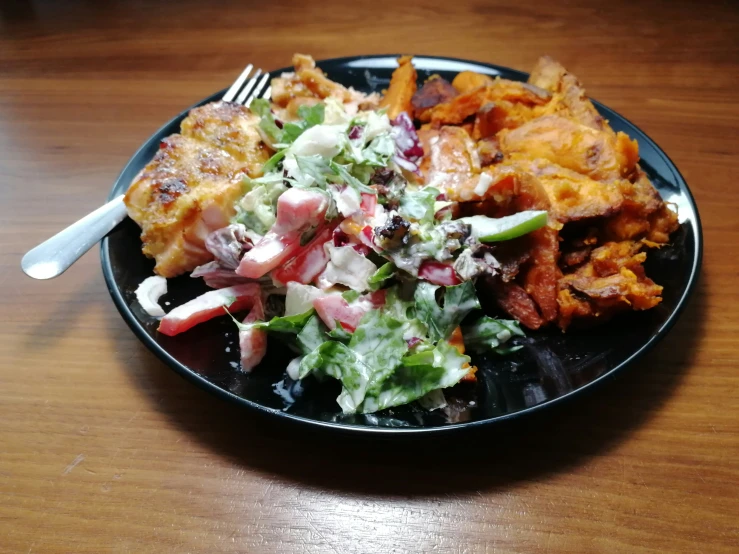 a plate full of food on a table with a fork