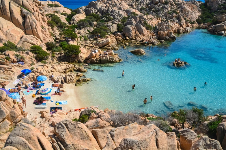 people are playing in the blue ocean at a beach