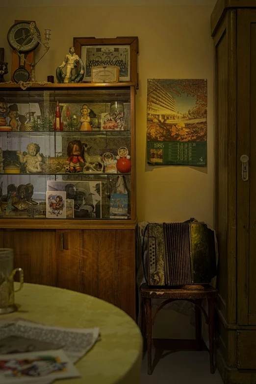 a small table with chairs and shelves with many things on it