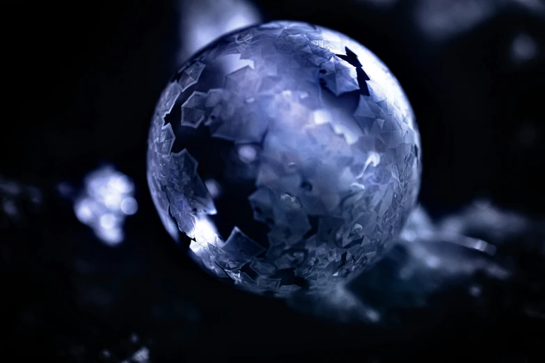 an abstract ball sitting in front of some tree nches