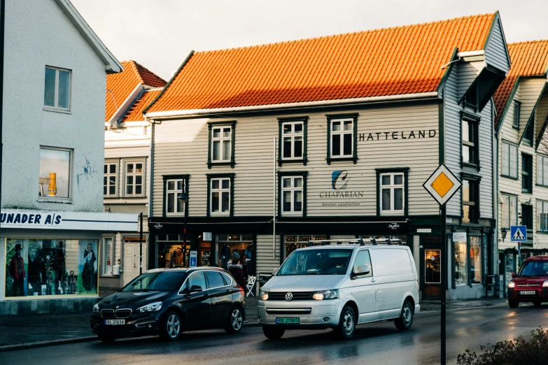 a couple of cars parked in front of a building