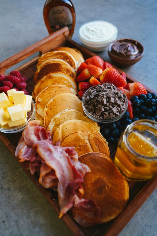 a wooden tray filled with lots of food