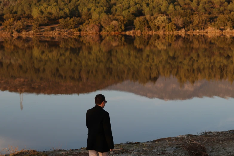 a man is looking out at the water