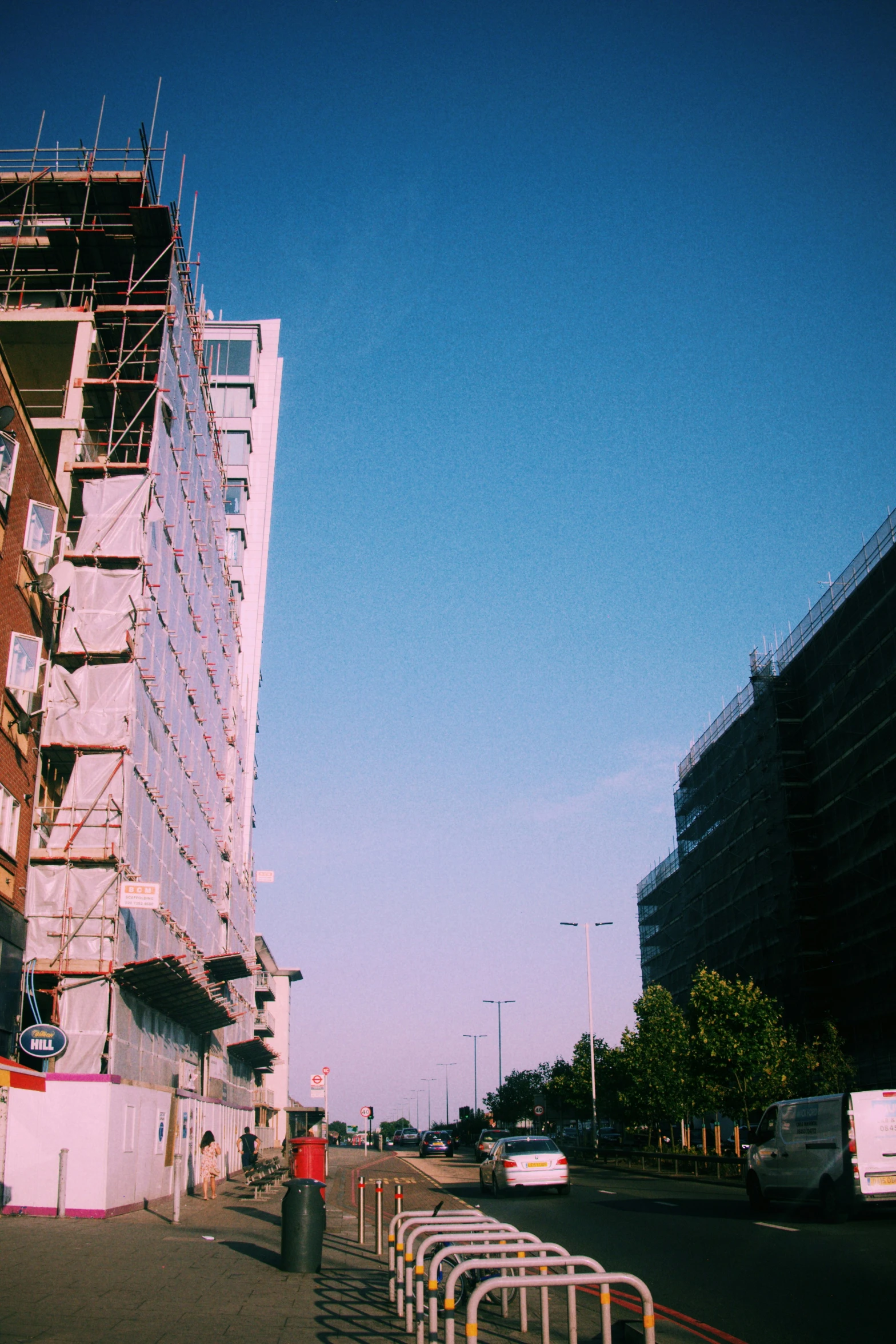 some people are sitting outside near a big building