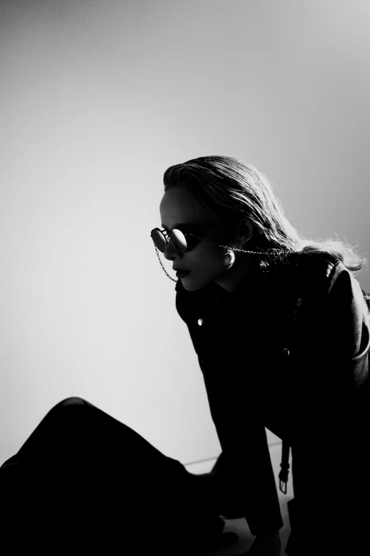 a woman with sunglasses sitting in front of a computer