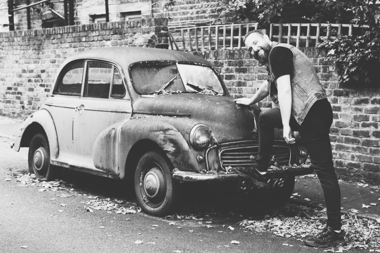 the old man is fixing the car on the roadside