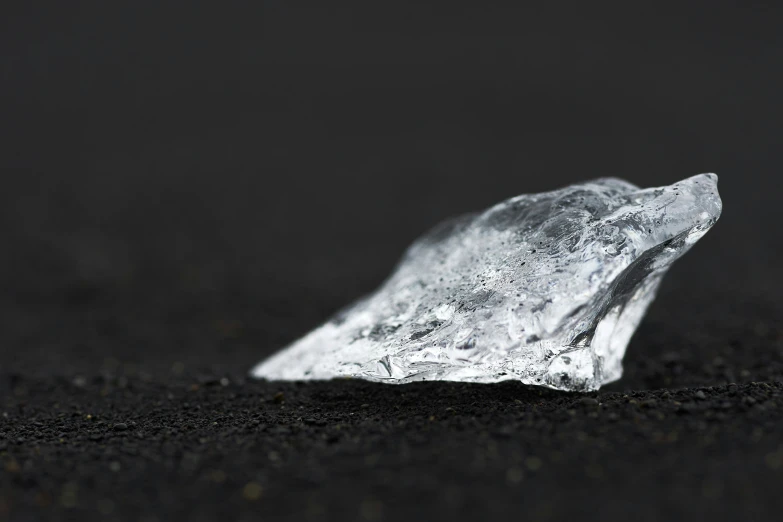 ice crystals and black sand on dark ground