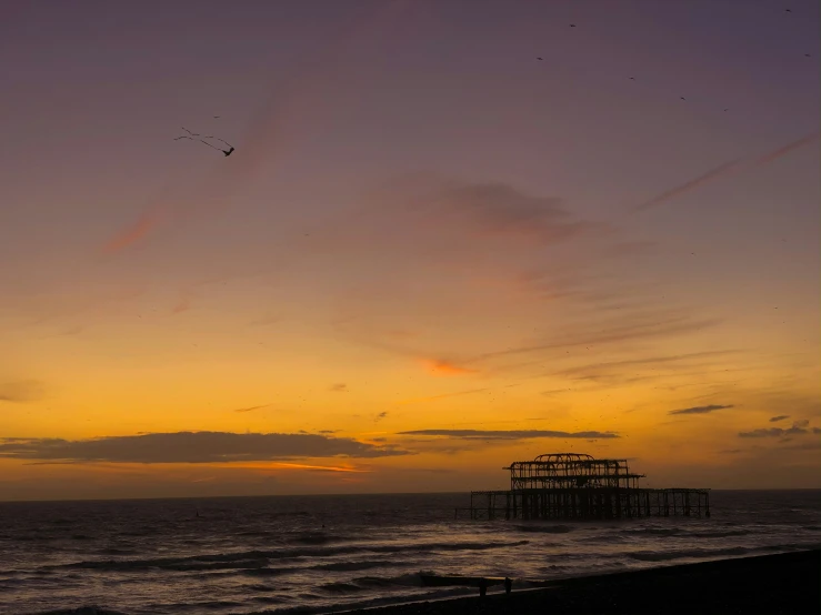 an orange and purple sunset in the sky