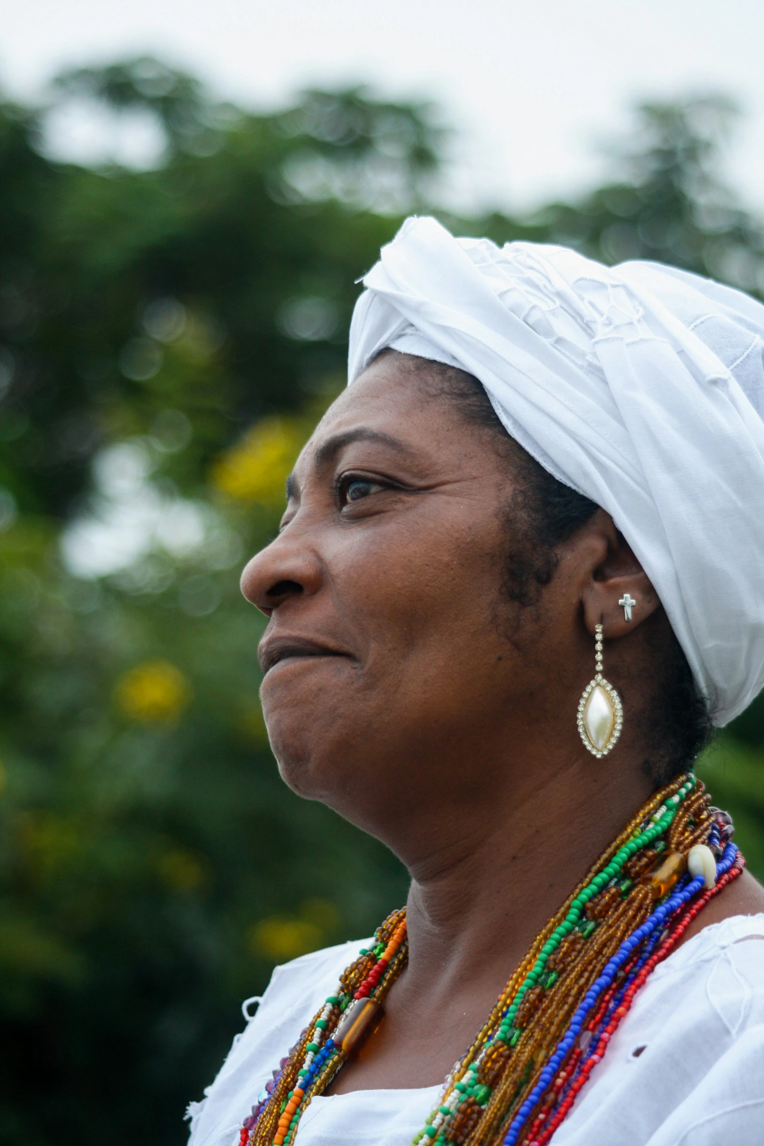 a woman wearing a head scarf and earrings