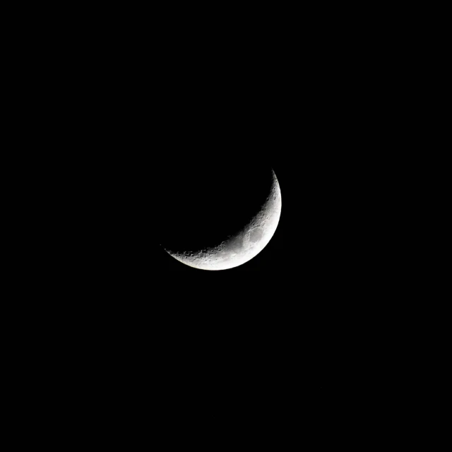 the crescent is half in shadow from a telescope