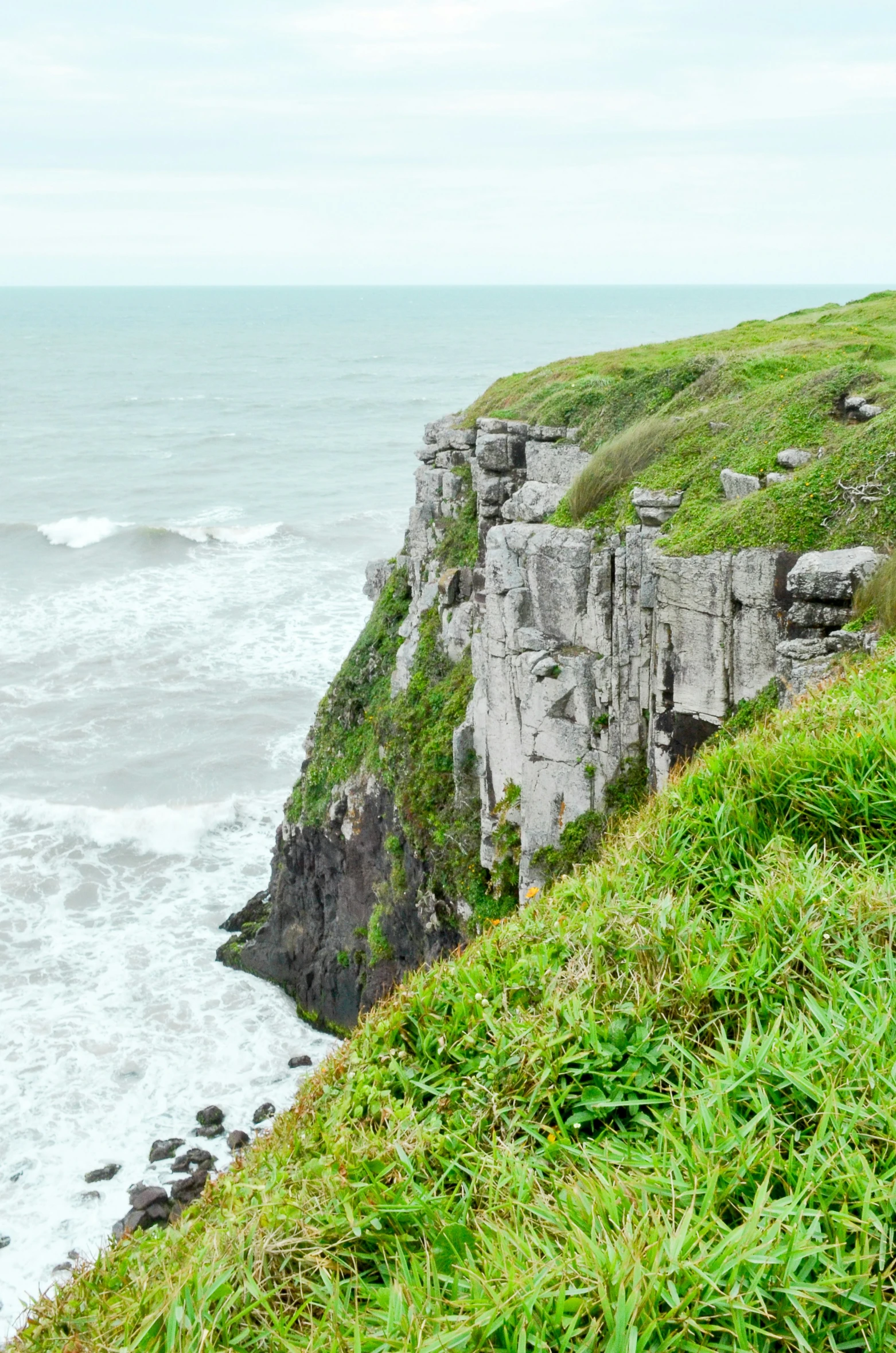 an old style rock structure at the edge of the ocean