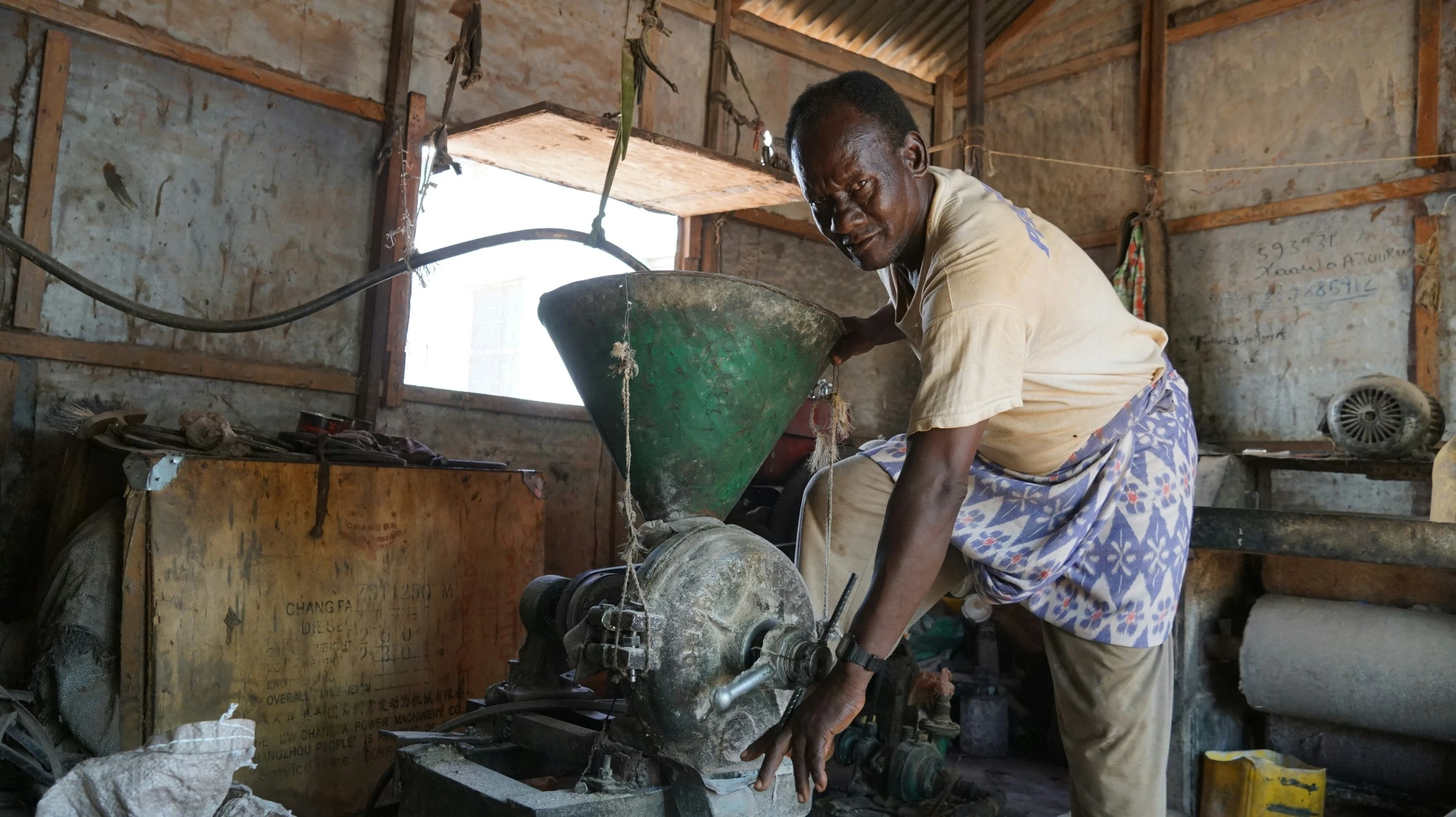 a woman is working on an older steel plant