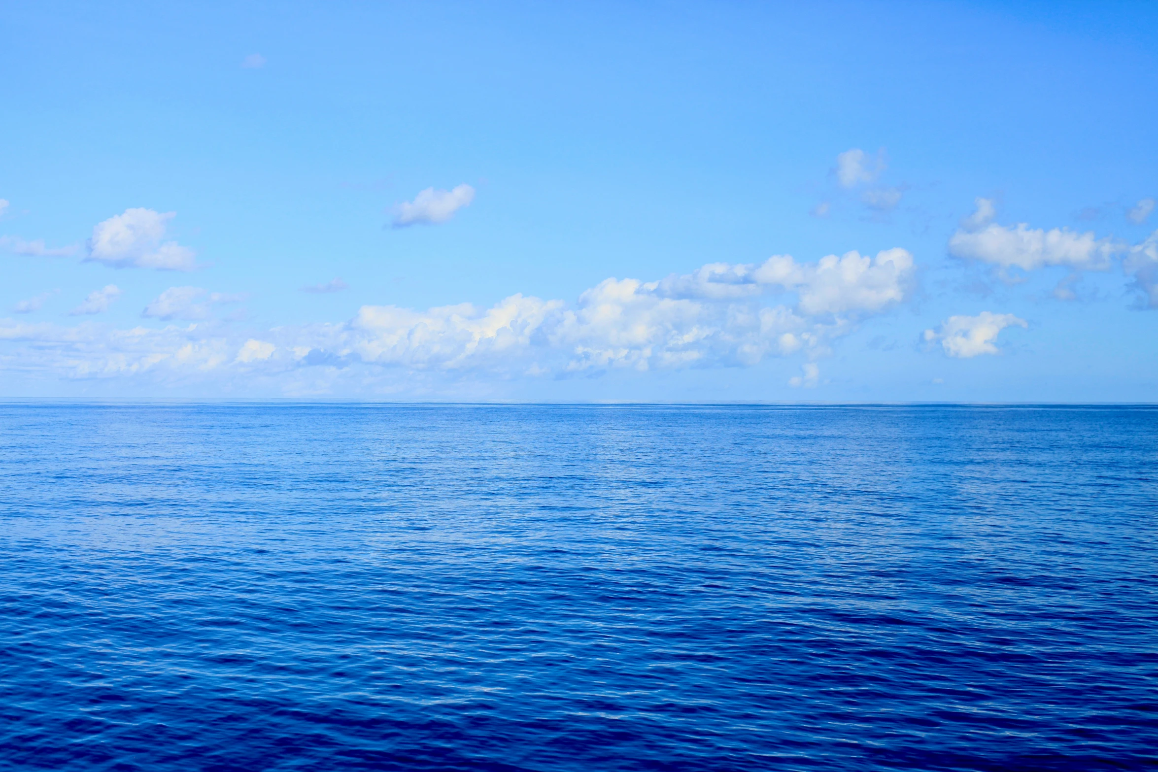 the view of an ocean with blue water