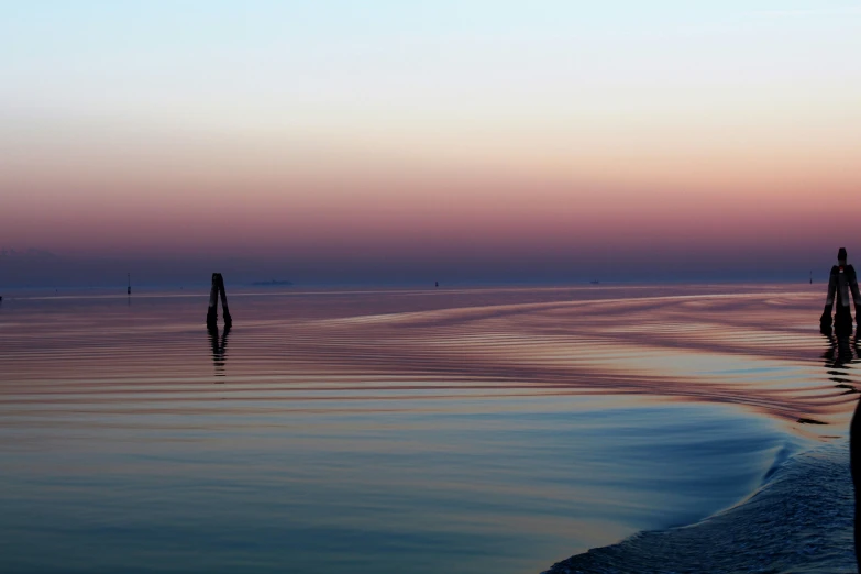 a pink sky and some very pretty water