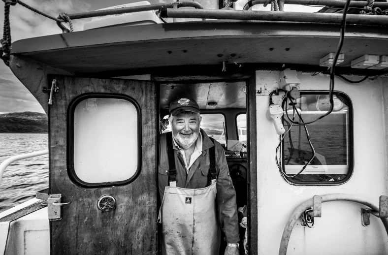 a man is standing on the door of a boat