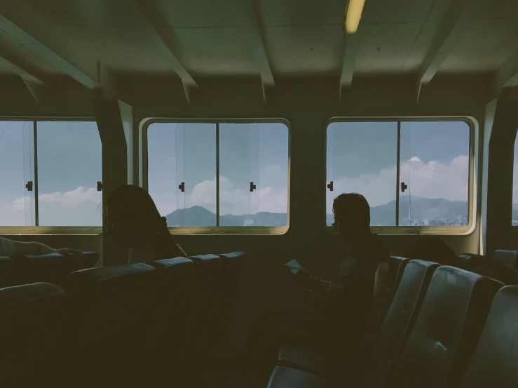 two women standing on the inside of a train