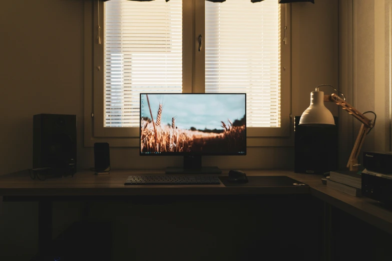 the computer screen is turned on next to a pair of speakers