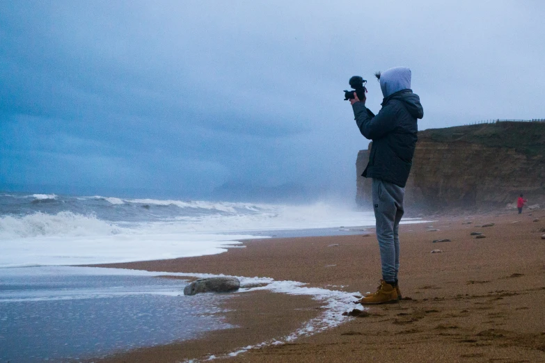 a person standing on a beach looking at the ocean