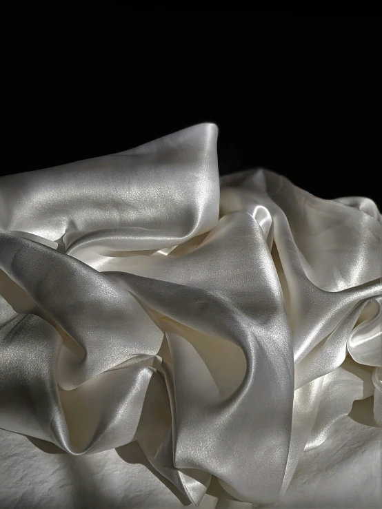 white satin fabric that has been placed on a table