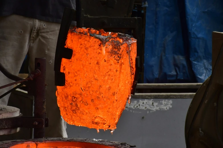an orange object sitting on top of a metal device