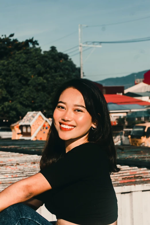 a woman is posing for a picture on the rooftop