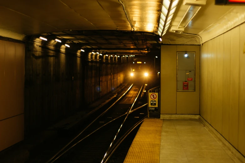 a train station platform with the doors closed and lights on