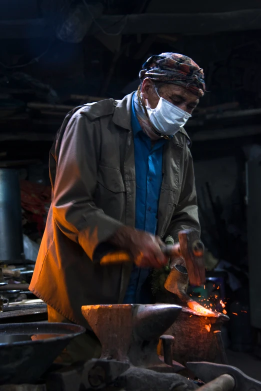 a man working on soing with a mask and face covering