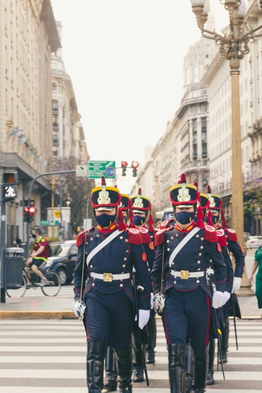 a military unit is marching down the street