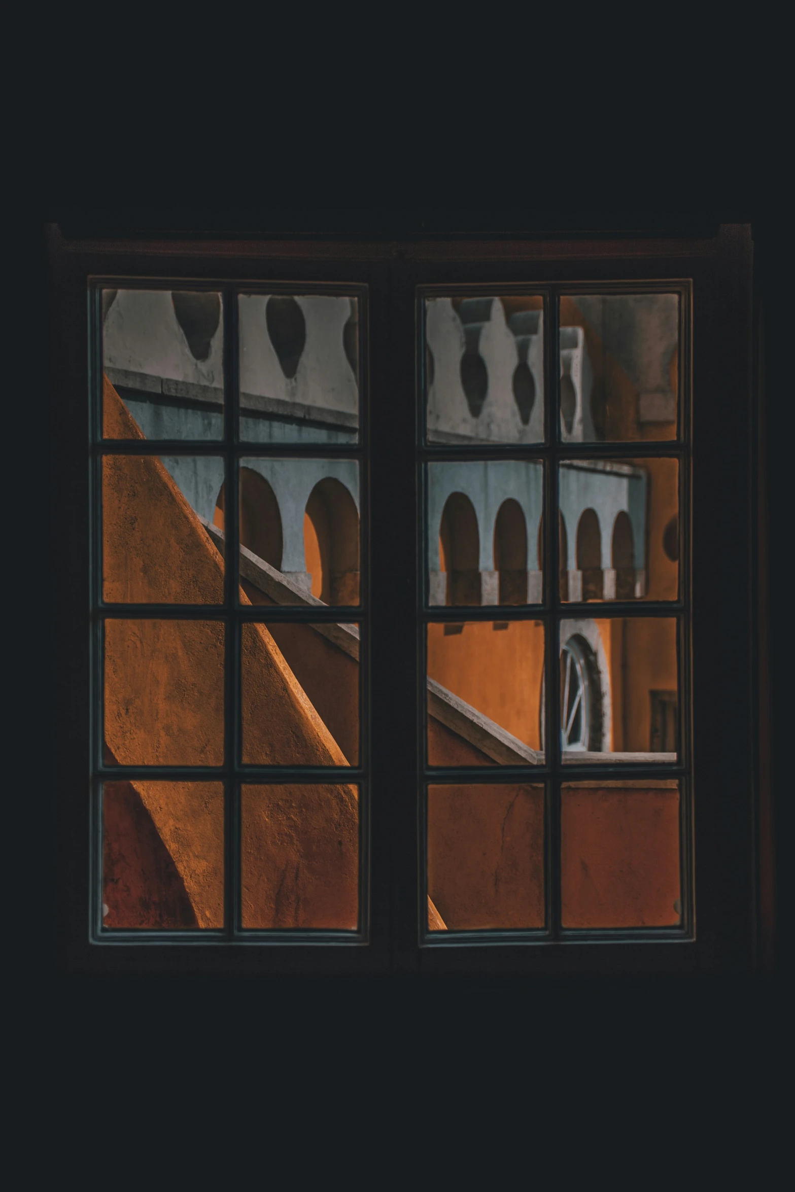 a window with a reflection of a street in it