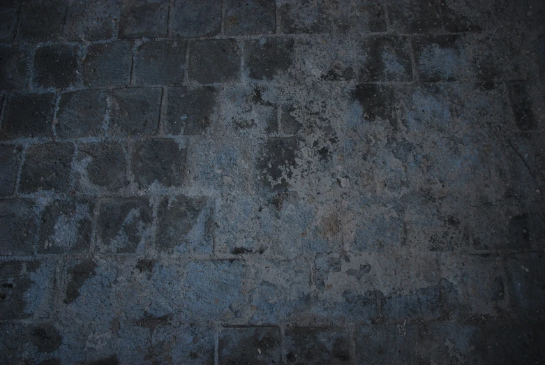 a black and gray wall that looks to be made from old cement