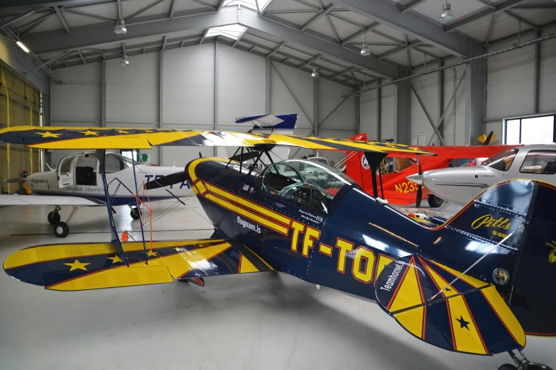 a couple of people in a garage with some airplanes