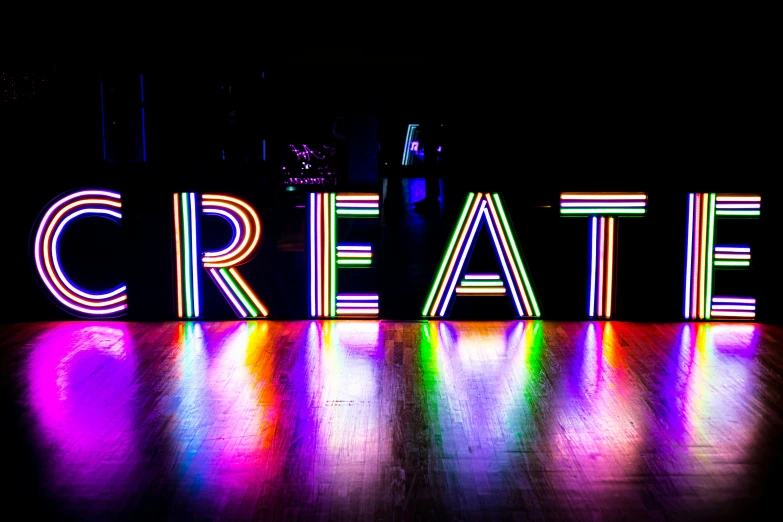 the words create are lit by colored lights