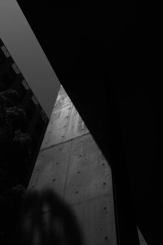 a man with an umbrella looking through the window of a building