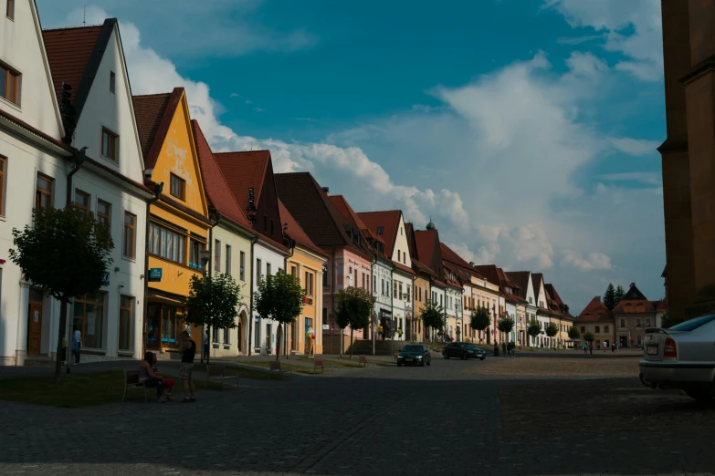 several buildings line the road, one of which has a red door