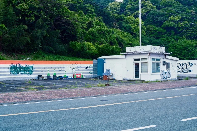 a lone building sitting at the side of a road