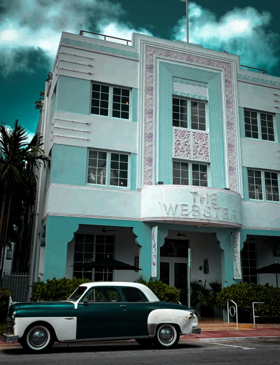 the car is parked in front of an old building