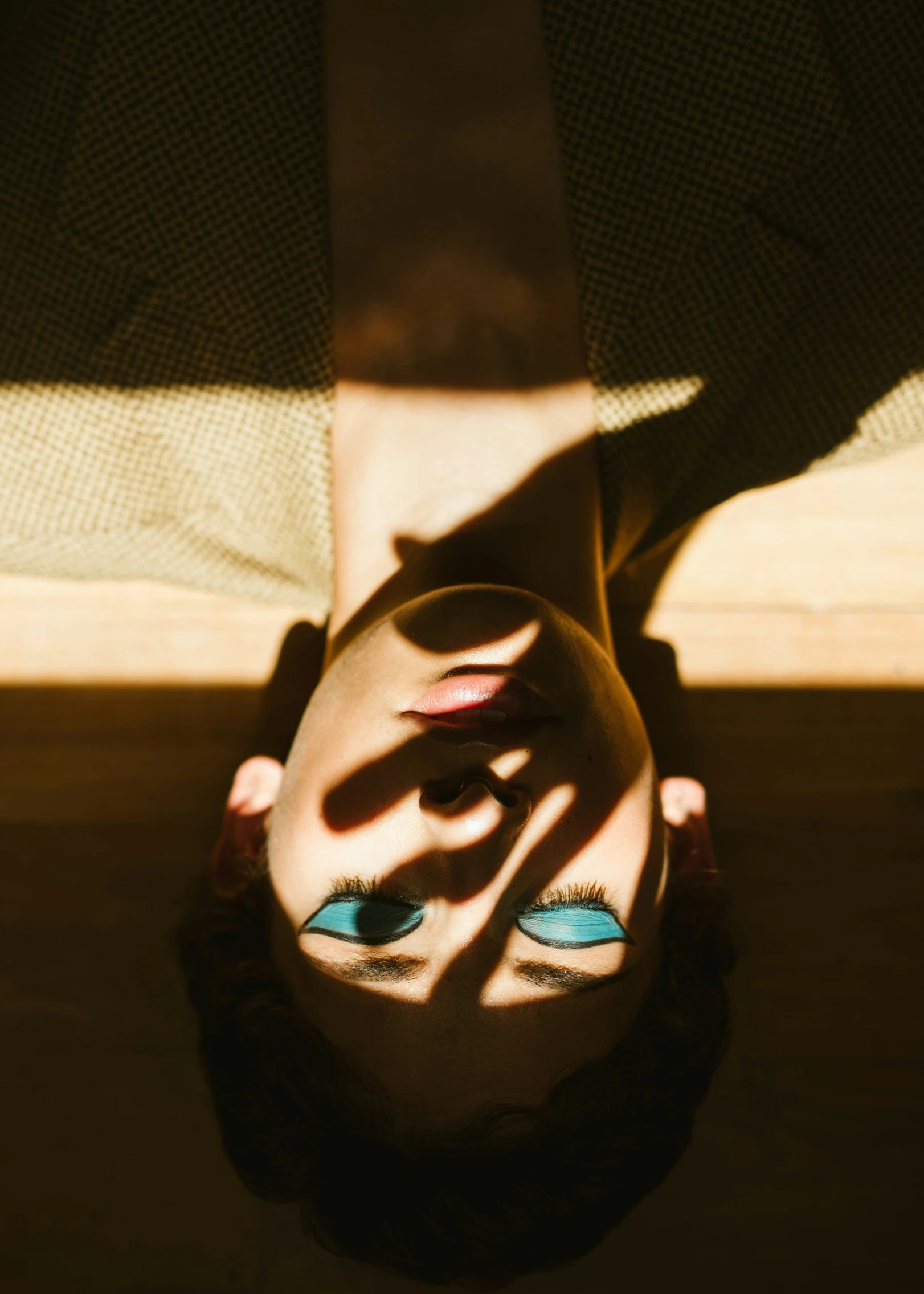 a person standing in the middle of a floor with bright shadow