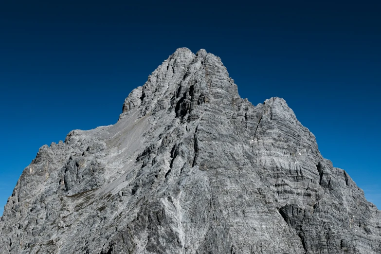 the side of a rock formation and clear blue sky