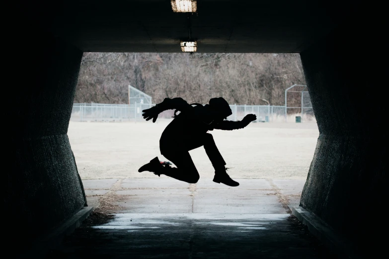 the silhouette of a person jumping on a skateboard