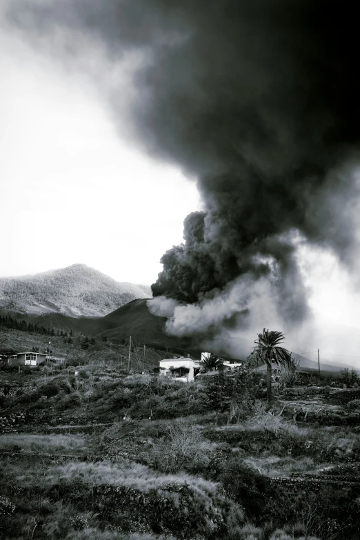 black smoke billowing out into the sky from a building