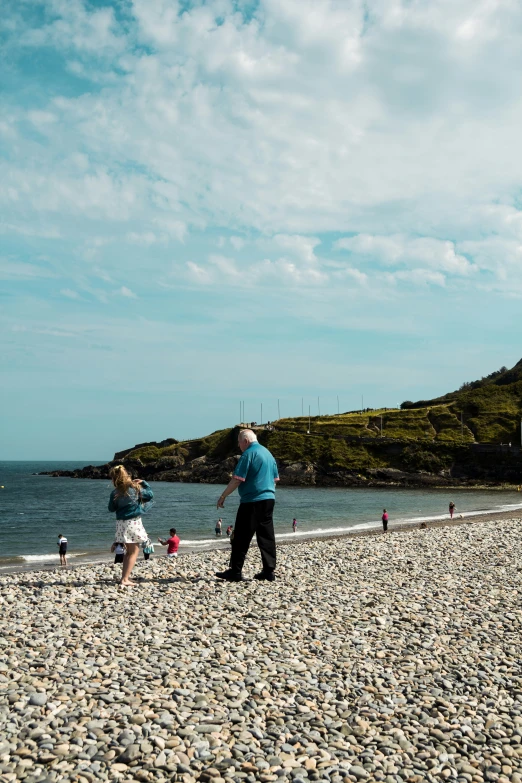 two adults are flying kites at the beach