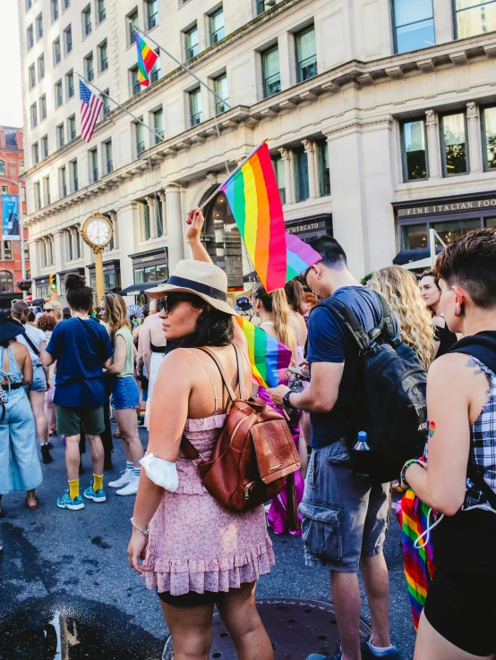 a group of people standing around with some holding flags