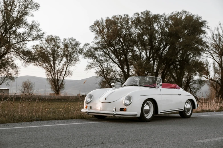 a white car sitting on the side of a road