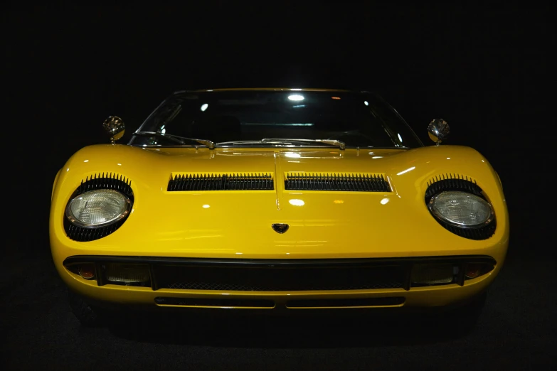 a sports car parked in a dark room