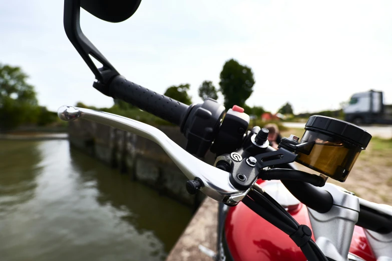 the handlebars on a motorcycle near a body of water