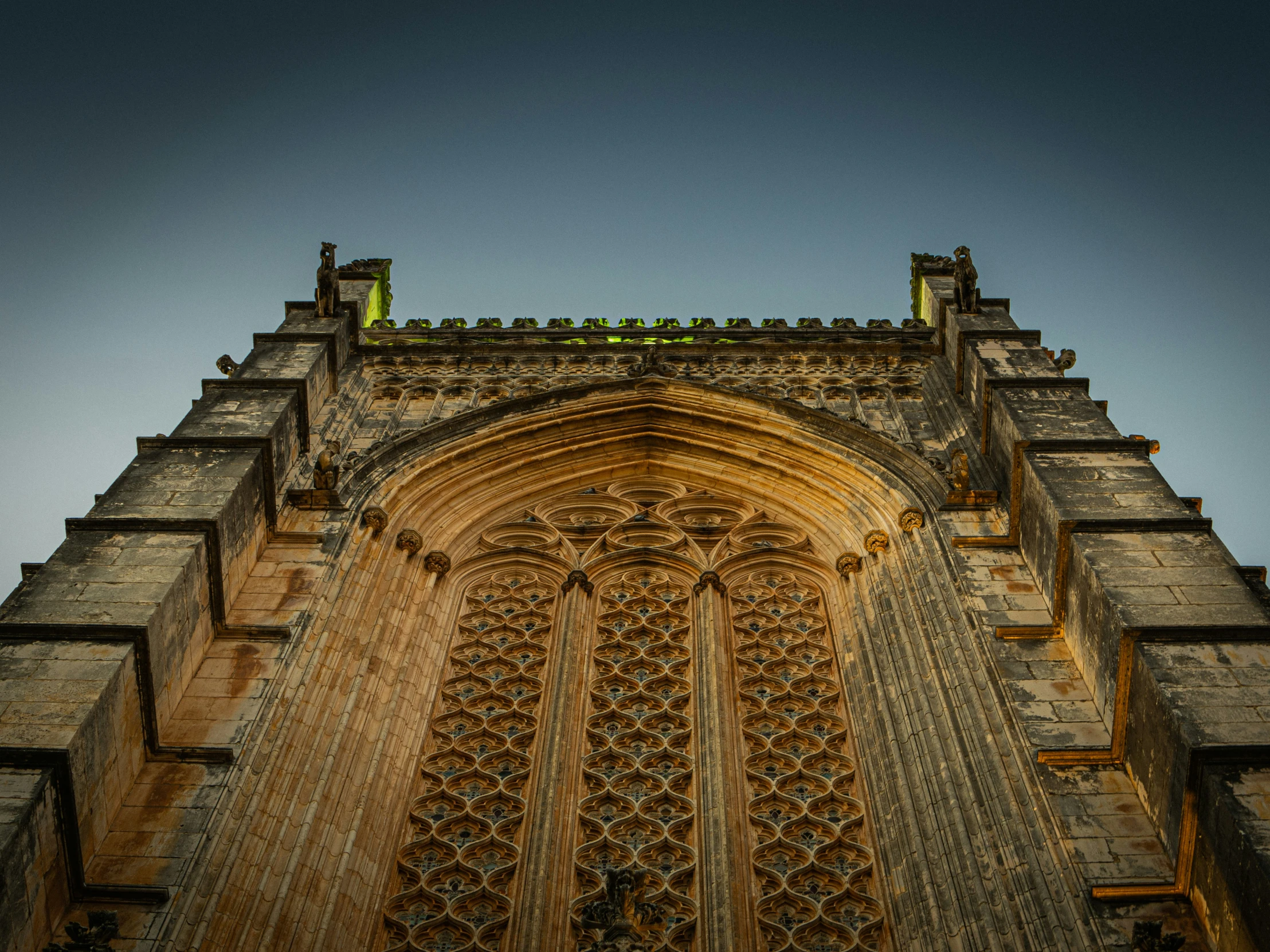 looking up at the wall and window of an ornate building